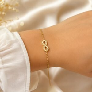 Stone studded infinity bracelet